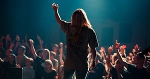 Leader on stage in front of a crowd